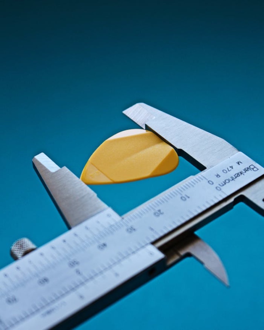 A precision caliper measuring a machined metal component