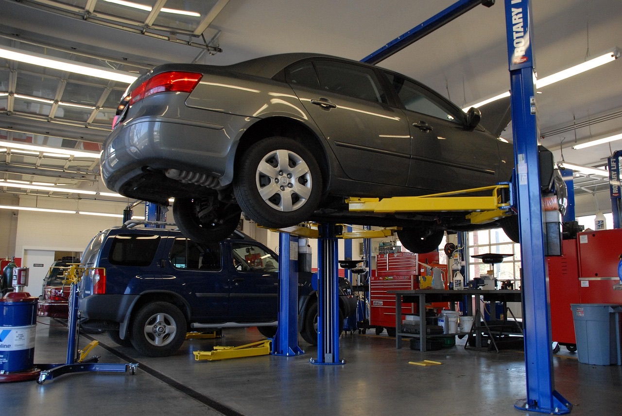 A vehicle raised on a workshop lift for servicing