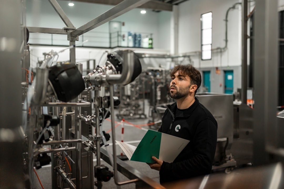 A CES engineer inspecting machinery on a factory floor